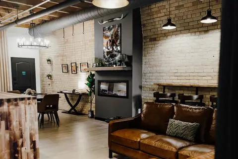 Sk\u00f8l H\u00fcs living room with leather sofa and exposed brick