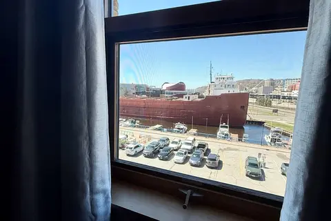 Window view of the William A. Irvin ship from Sk\u00f8l H\u00fcs